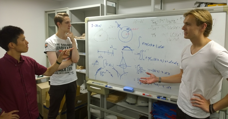 Mr. Fluri (center) and Mr. Riebartsch (right) from ETH Zürich discussing research with a colleague at the Research Center for the Early Universe